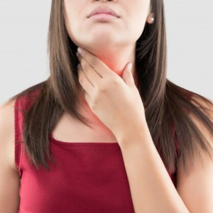 asian-woman-with-sore-throat-thyroid-gland-against-gray-background_46527-279